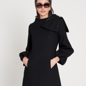 This black wool dress is designed to flatter the figure and can be made and includes embellishments as desired.
