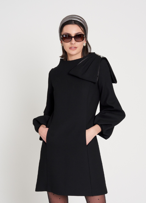 This black wool dress is designed to flatter the figure and can be made and includes embellishments as desired.